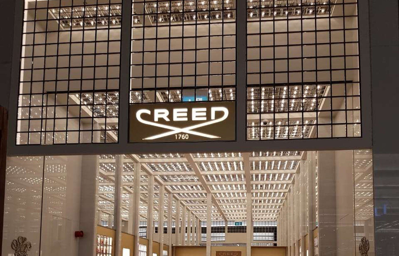 Detail crop of CREED storefront and interior sightline