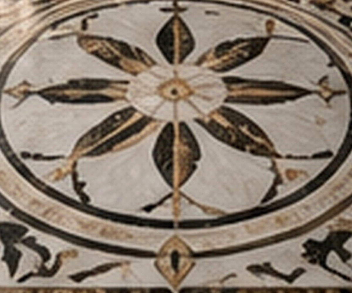 Close view of a multi-piece marble waterjet inlay showing curved stone segments and precision joints