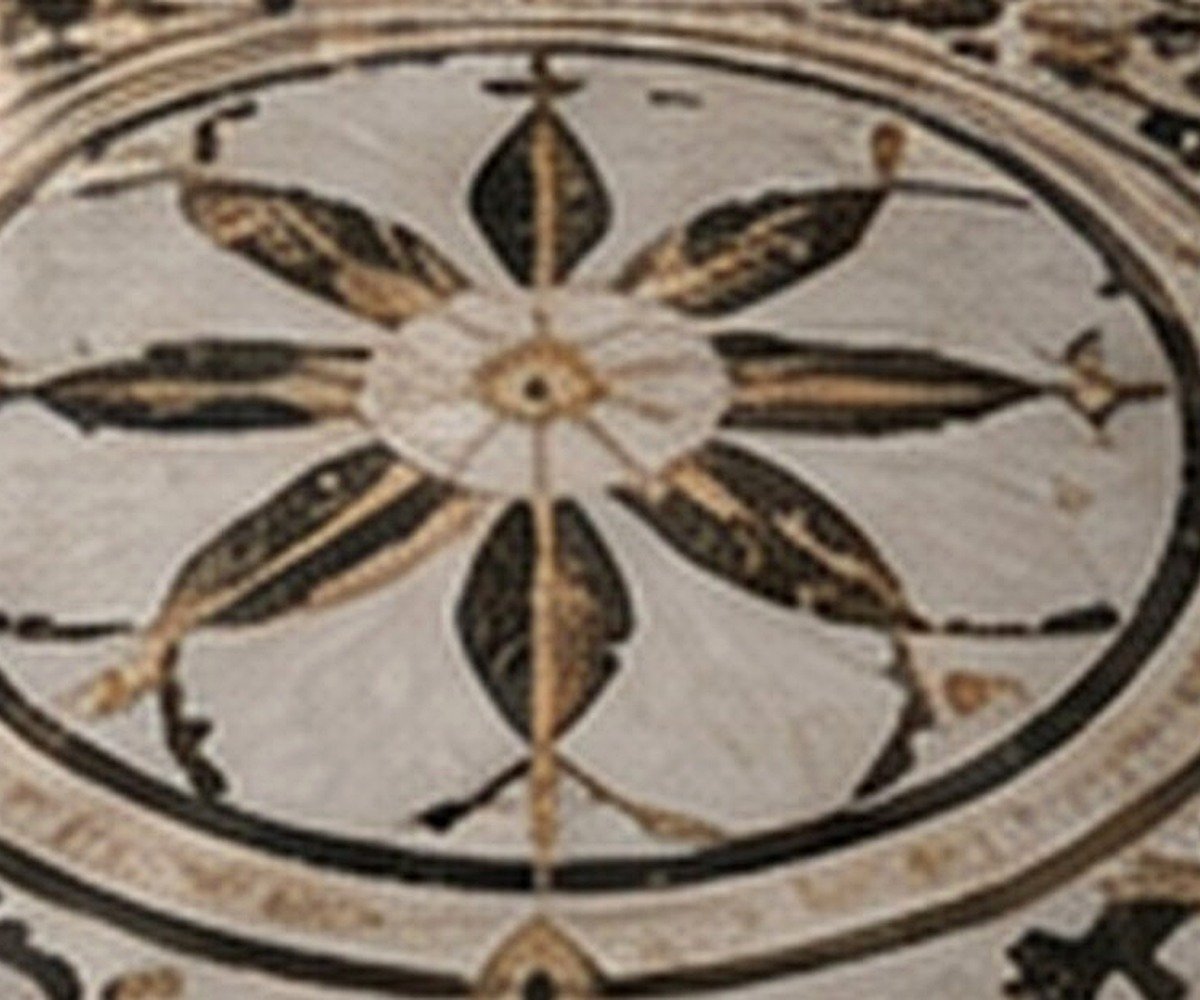 Finished decorative marble inlay medallion showing contrasting natural stone colours and precise curved joints